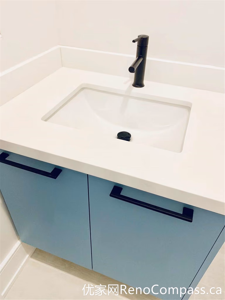 A close-up view of the custom bathroom vanity from this Markham renovation showcases a seamless integrated sink, soft blue cabinetry, and a matte black faucet. The clean lines and durable materials reflect a modern design approach focused on both functionality and long-term performance.
