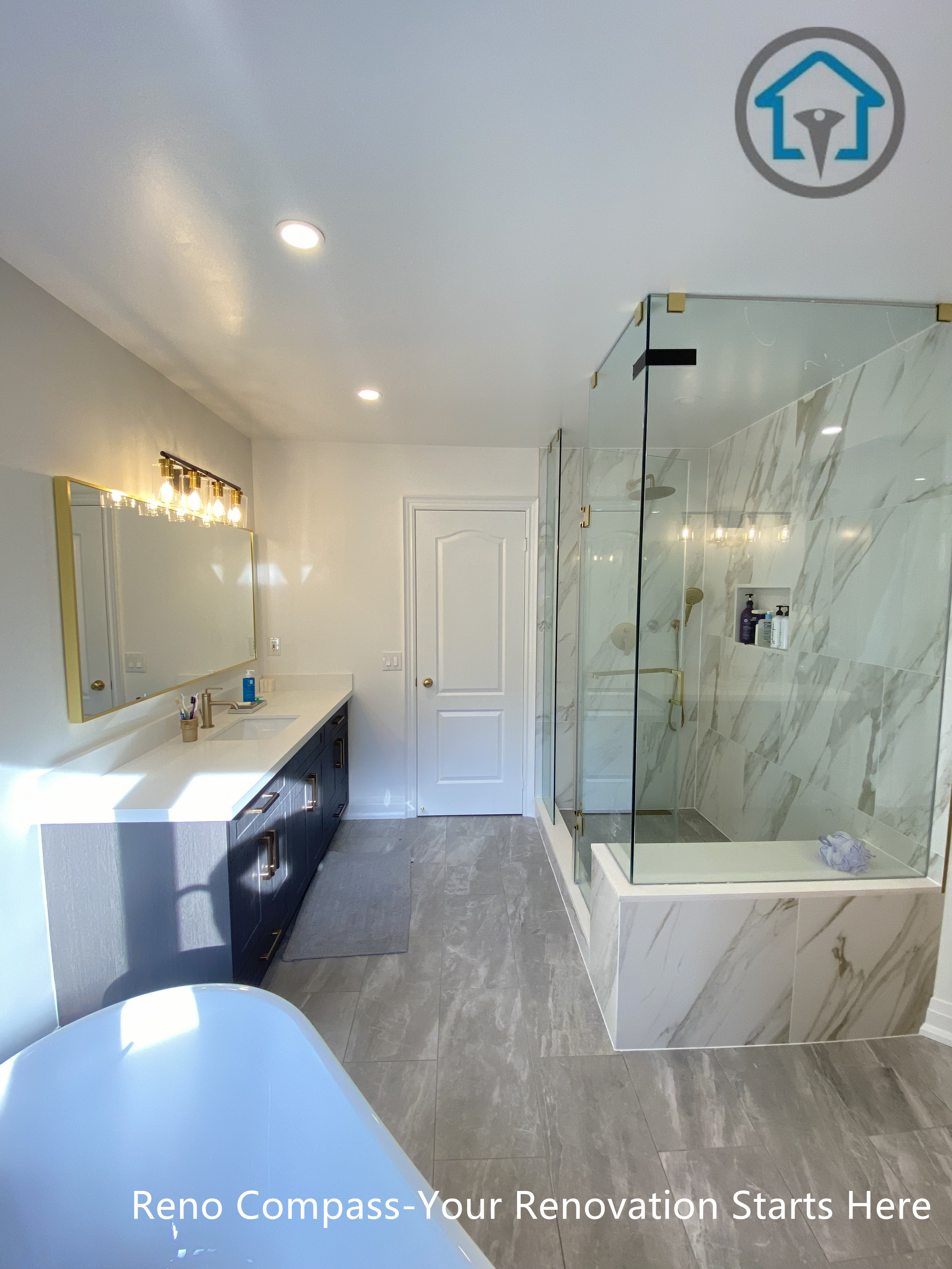 Spacious Markham bathroom showcasing a double vanity, frameless glass shower with marble-look tiles, and a clean, well-balanced layout.