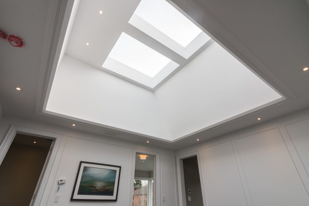 As part of this 4,500 sq ft luxury interior renovation in Toronto, a custom skylight installation and recessed ceiling design were introduced to enhance natural lighting and spatial openness. The layered tray ceiling with integrated pot lights creates a clean architectural finish while maximizing daylight throughout the space. Completed by a professional Toronto Renovation Company, Reno Compass Inc., this upgrade adds both visual impact and long-term property value through thoughtful modern design.