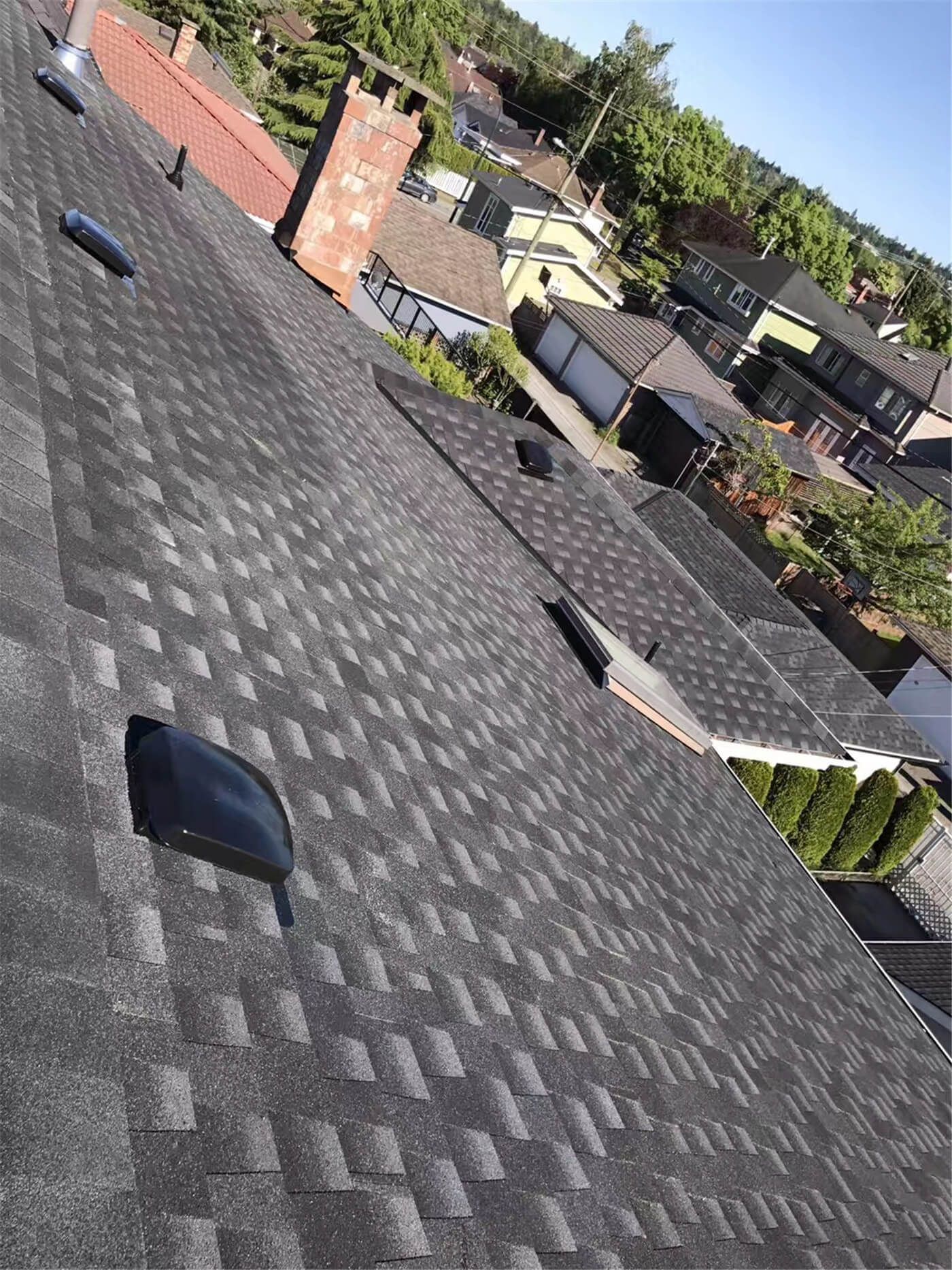 New asphalt shingle roof installation in Toronto, showing precise shingle alignment, proper underlayment coverage, and clean roof edge detailing. The roofing system includes upgraded flashing and vent pipe installation to ensure effective water drainage, ventilation, and long-term weather resistance. This roof replacement improves both durability and curb appeal while meeting Toronto building code standards.