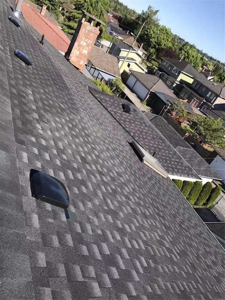 New asphalt shingle roof installation in Toronto, showing precise shingle alignment, proper underlayment coverage, and clean roof edge detailing. The roofing system includes upgraded flashing and vent pipe installation to ensure effective water drainage, ventilation, and long-term weather resistance. This roof replacement improves both durability and curb appeal while meeting Toronto building code standards.