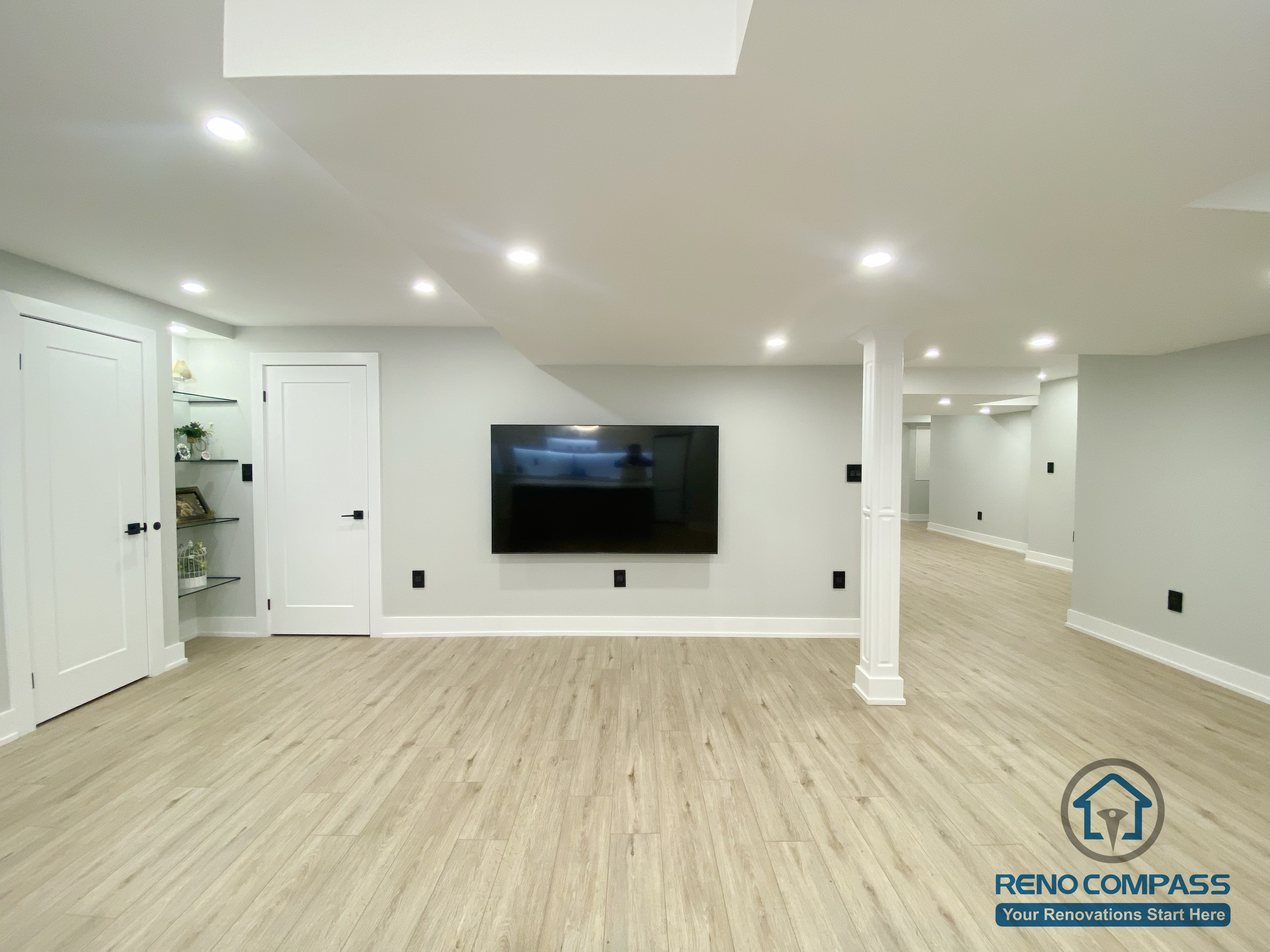 This Aurora basement renovation showcases a bright and spacious living area with recessed ceiling lighting, wood-look flooring, and a clean wall-mounted TV feature. The open layout enhances flow and functionality, making the basement ideal for family entertainment, relaxation, or multi-purpose use. Completed by a Toronto renovation company, this project reflects modern basement design with a focus on comfort, lighting, and efficient space utilization.