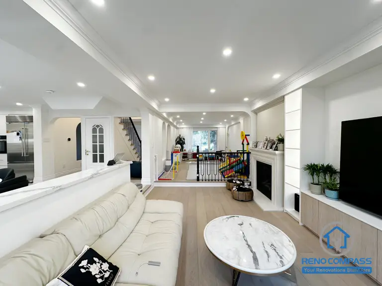 This Markham interior renovation reimagines the main living area as a bright, open-concept space that seamlessly connects lounging, dining, and family activity zones. The layout is designed to enhance visual continuity while maintaining comfortable separation between different functions of the home.

A half-height partition helps define the living room without blocking sightlines, allowing natural light to flow through the space. Recessed ceiling lighting and consistent architectural details create a clean, cohesive look throughout the interior. The open connection to the kitchen and family areas supports everyday interaction and makes the space ideal for both relaxation and entertaining.

By focusing on layout balance, lighting design, and long-term usability, this renovation delivers a refined yet practical interior environment suited for modern family living in Markham.