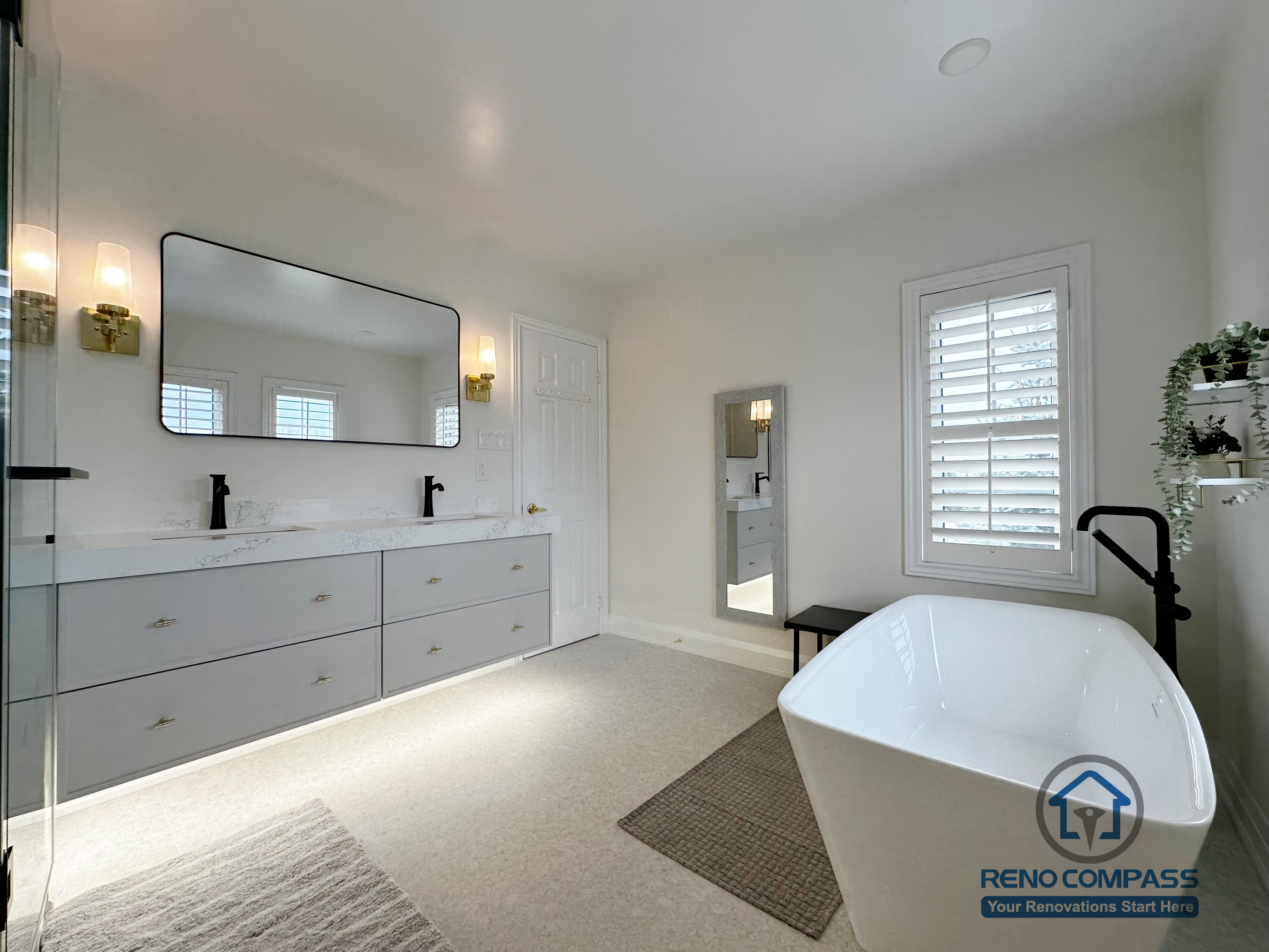 This Markham bathroom renovation features a wide double vanity with quartz countertops, soft integrated lighting, and classic wall sconces. A freestanding bathtub placed near natural light creates a calm, balanced atmosphere, while the overall layout prioritizes comfort, clarity, and everyday usability.