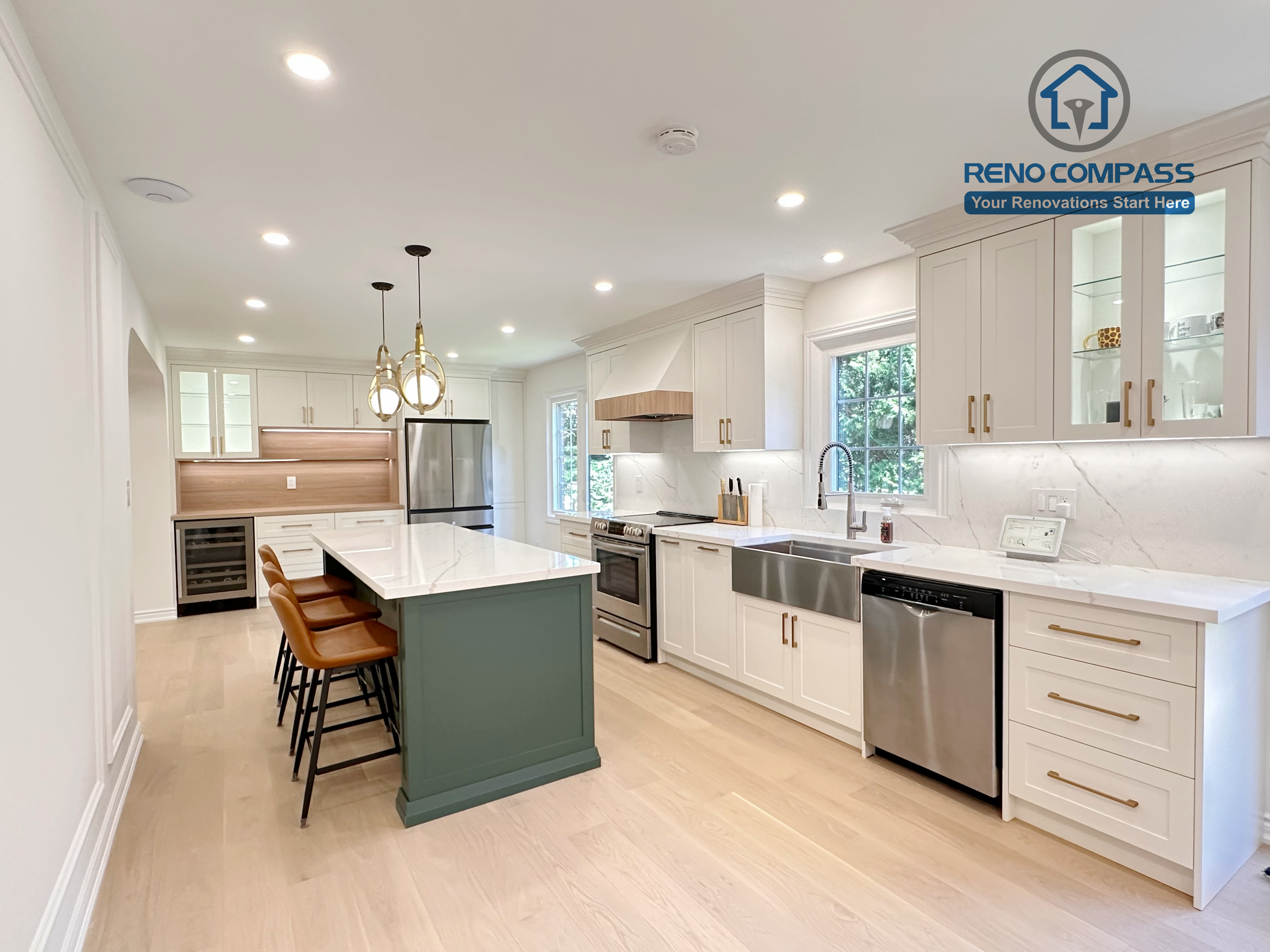 This Markham kitchen renovation highlights a spacious central island with seating, paired with a well-organized cooking area featuring quartz countertops, custom cabinetry, and stainless steel appliances. Pendant lighting and recessed ceiling lights provide balanced illumination, while wide-plank hardwood flooring enhances continuity throughout the space. Completed by a professional Toronto renovation company, Reno Compass Inc., the kitchen is designed for efficiency, comfort, and everyday use.