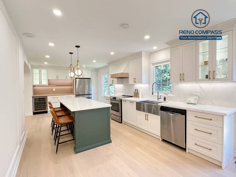 This Markham kitchen renovation highlights a spacious central island with seating, paired with a well-organized cooking area featuring quartz countertops, custom cabinetry, and stainless steel appliances. Pendant lighting and recessed ceiling lights provide balanced illumination, while wide-plank hardwood flooring enhances continuity throughout the space. Completed by a professional Toronto renovation company, Reno Compass Inc., the kitchen is designed for efficiency, comfort, and everyday use.