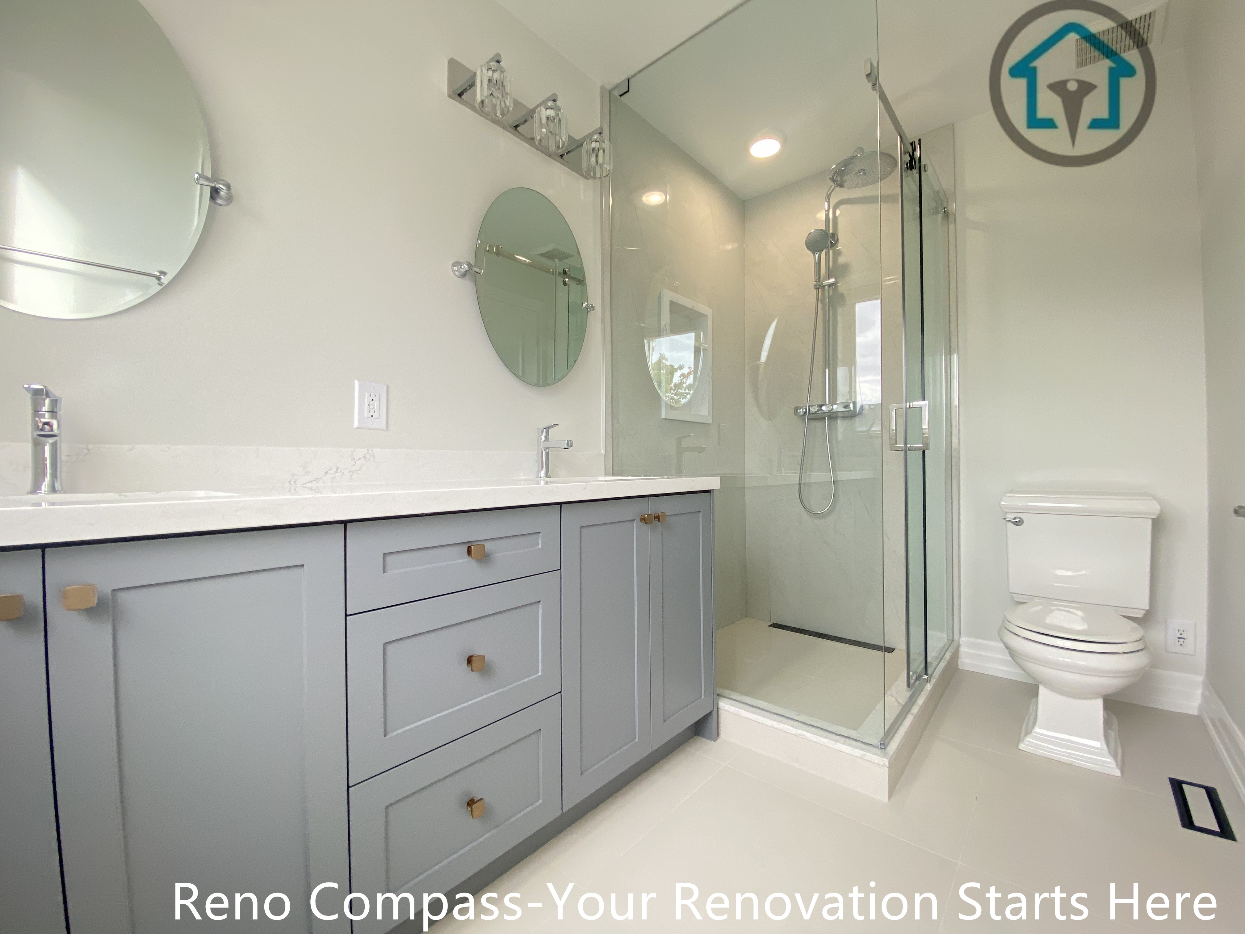 This bathroom design pairs a double-sink vanity with a frameless glass shower to create a bright and efficient layout. Soft grey cabinetry adds warmth and storage, while the clean-lined glass enclosure keeps the space visually open. Light finishes throughout the room enhance clarity and comfort for everyday use.