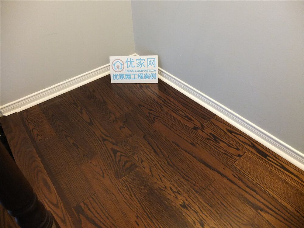 This close-up image showcases the rich natural wood grain of newly installed hardwood flooring in a Mississauga home renovation project. The flooring features deep brown tones, precise plank alignment, and clean baseboard finishes that create a refined and durable interior surface. As a professional Toronto Renovation Company, Reno Compass specializes in high-quality hardwood flooring installation that enhances both aesthetic appeal and long-term value for residential properties.