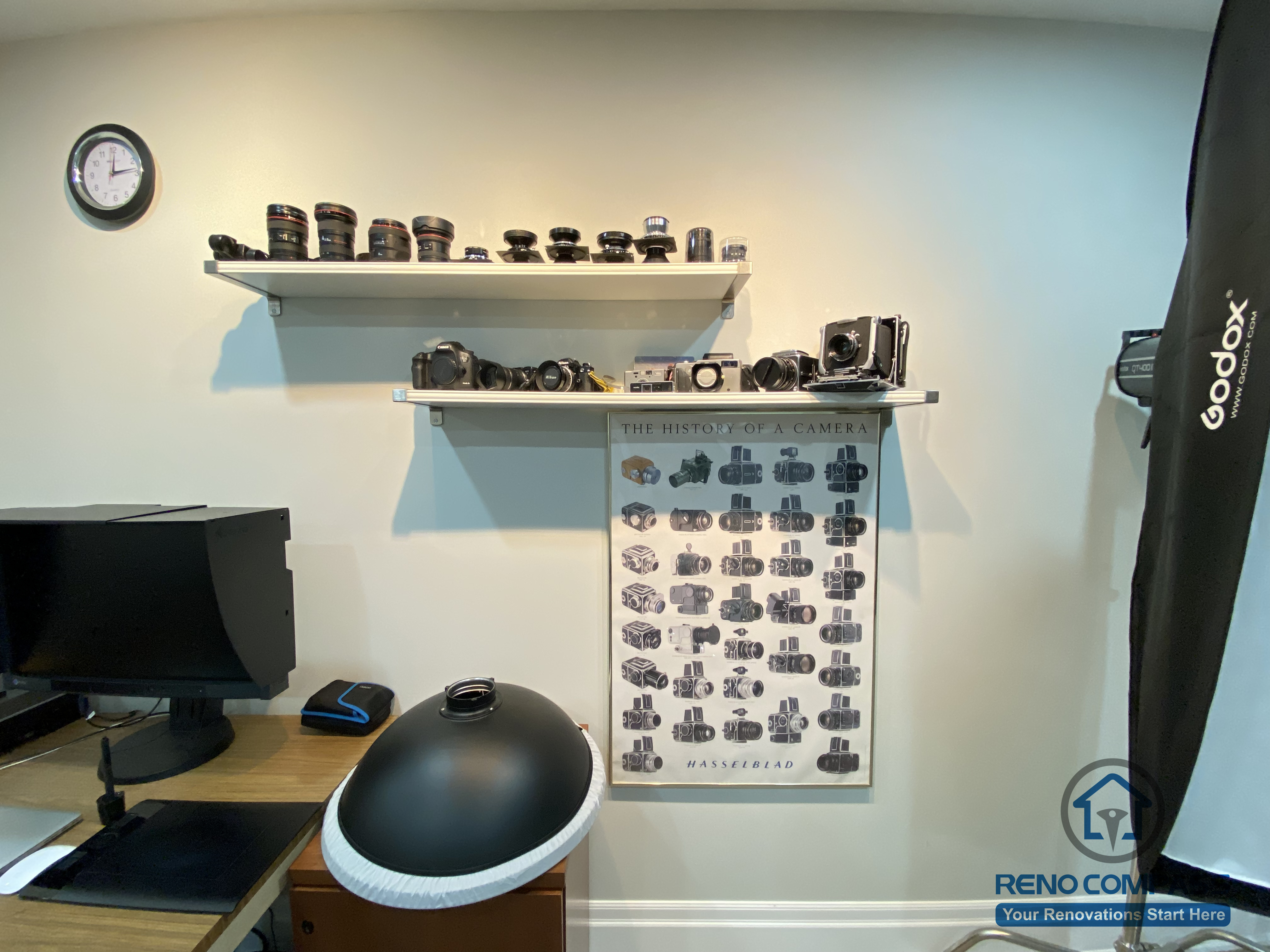 This Oakville basement renovation features a dedicated home office and creative workspace designed for productivity and personal interests. Wall-mounted display shelves provide organized storage for cameras and equipment, while a functional desk setup supports focused work and hobbies. Neutral wall tones, clean lines, and recessed lighting keep the space bright and uncluttered. As a trusted Toronto renovation company, Reno Compass creates customized basement offices that balance storage, lighting, and comfort, transforming underused spaces into efficient and inspiring work environments.