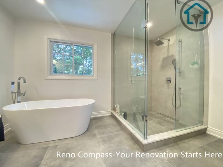 This image highlights the large-format porcelain floor tiles used in an Oakville bathroom renovation, creating a clean, seamless foundation for the space. The neutral grey tone enhances visual continuity, reduces grout lines, and improves long-term durability and ease of maintenance. Carefully aligned flooring transitions complement the modern bathroom layout and contribute to a refined, minimalist finish.