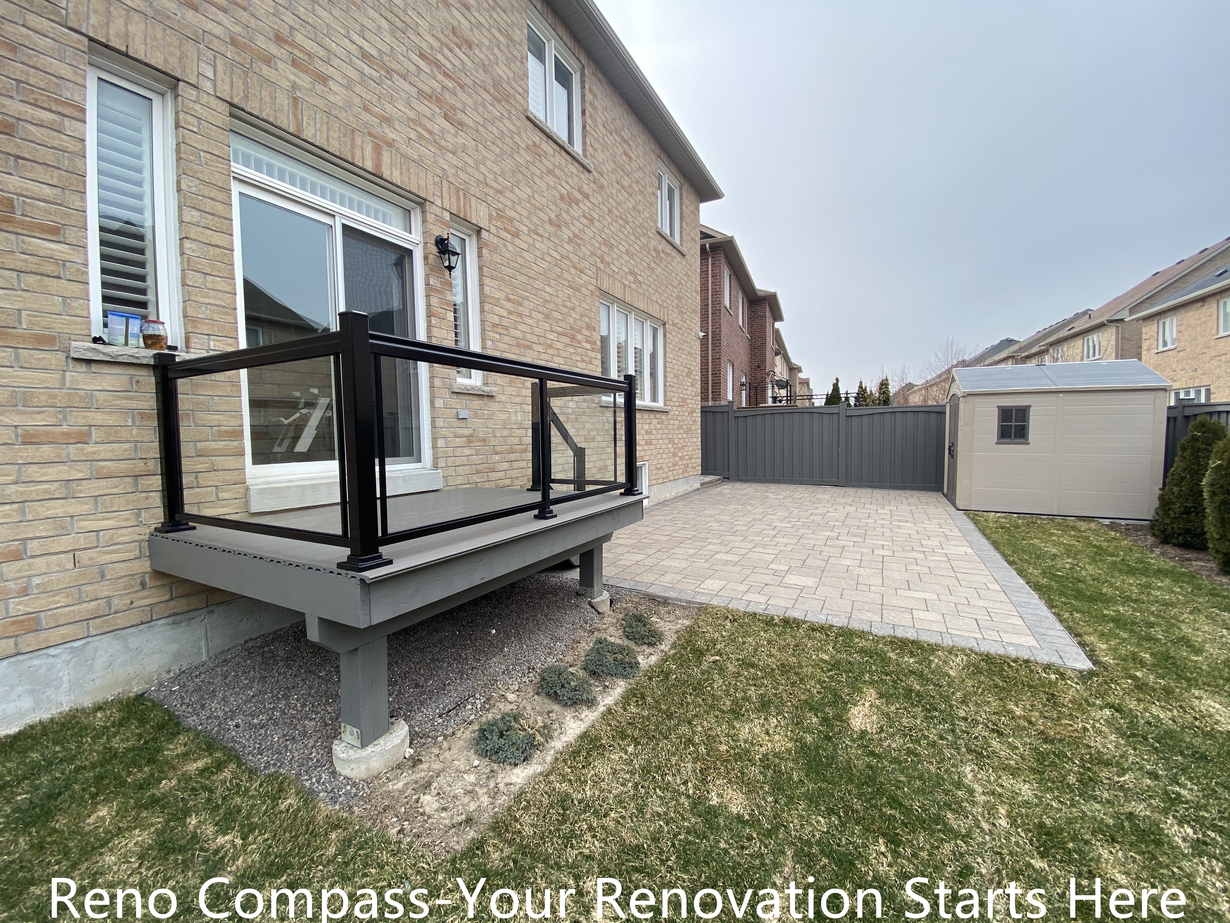 Composite backyard deck renovation in Newmarket featuring durable deck boards and black aluminum railing with clean, modern lines. The raised deck structure provides a safe and functional outdoor platform while enhancing the connection between indoor living space and the backyard. Built by a professional Toronto renovation company with a focus on structural stability and long-term performance.