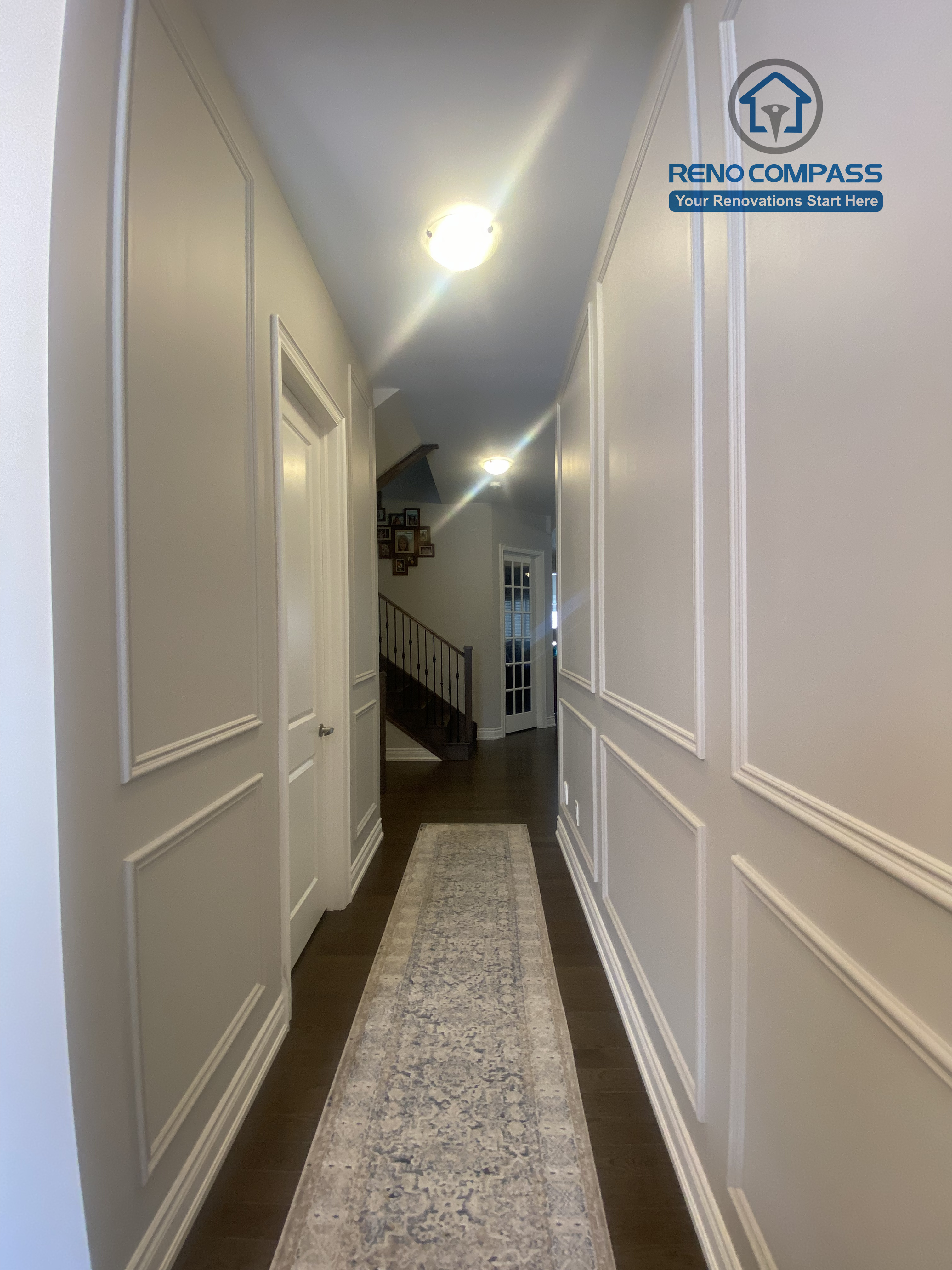 This Vaughan interior renovation highlights a refined hallway featuring built-in storage doors, classic wall paneling, and clean trim details. The space is designed with balanced proportions and subtle lighting, enhancing both functionality and elegance, completed by a professional Toronto renovation company.