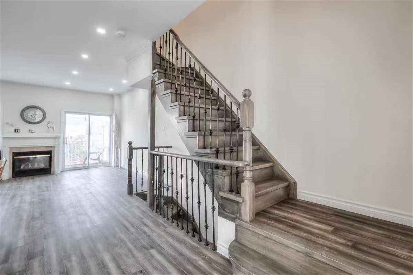 This Thornhill interior renovation highlights a beautifully upgraded staircase with modern iron railings, refinished wood steps, and new wood-style flooring throughout the main floor. The open-concept layout is enhanced with fresh paint, recessed lighting, and improved finishing details to create a bright and contemporary living space. Completed by a professional Toronto renovation team, this project showcases quality craftsmanship and modern interior transformation for a stylish and functional home.