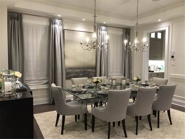 Elegant dining room in Toronto featuring full-height custom curtains with layered sheer and blackout drapery. The ceiling-mounted design enhances natural light control while adding a luxurious and refined atmosphere to the space.