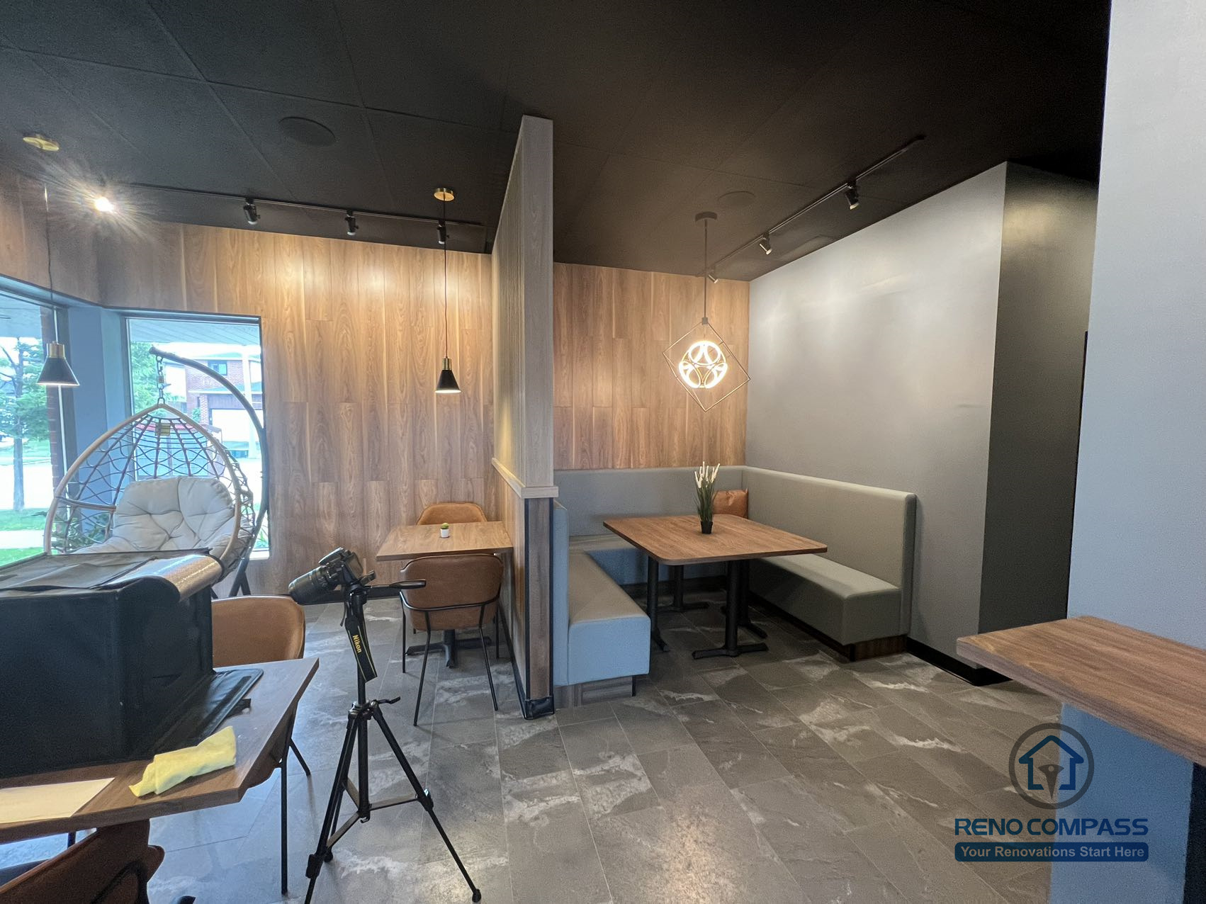 This Mississauga restaurant renovation features a semi-private booth seating area with custom millwork, wood panel accents, and integrated lighting. The layout creates a comfortable dining environment that enhances privacy while maintaining an open and modern restaurant interior.