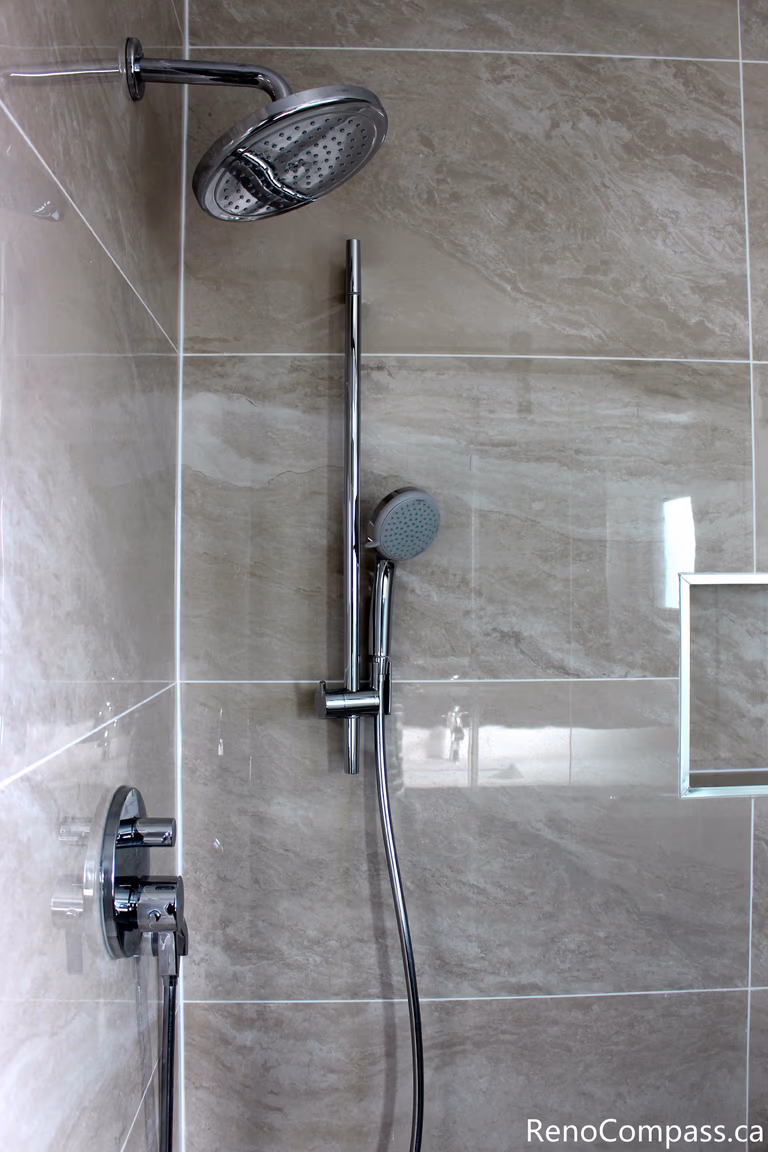 This Mississauga bathroom renovation focuses on the frameless glass shower enclosure, showcasing clean edges and minimal hardware. The transparent design enhances openness while maintaining a sleek, modern aesthetic.