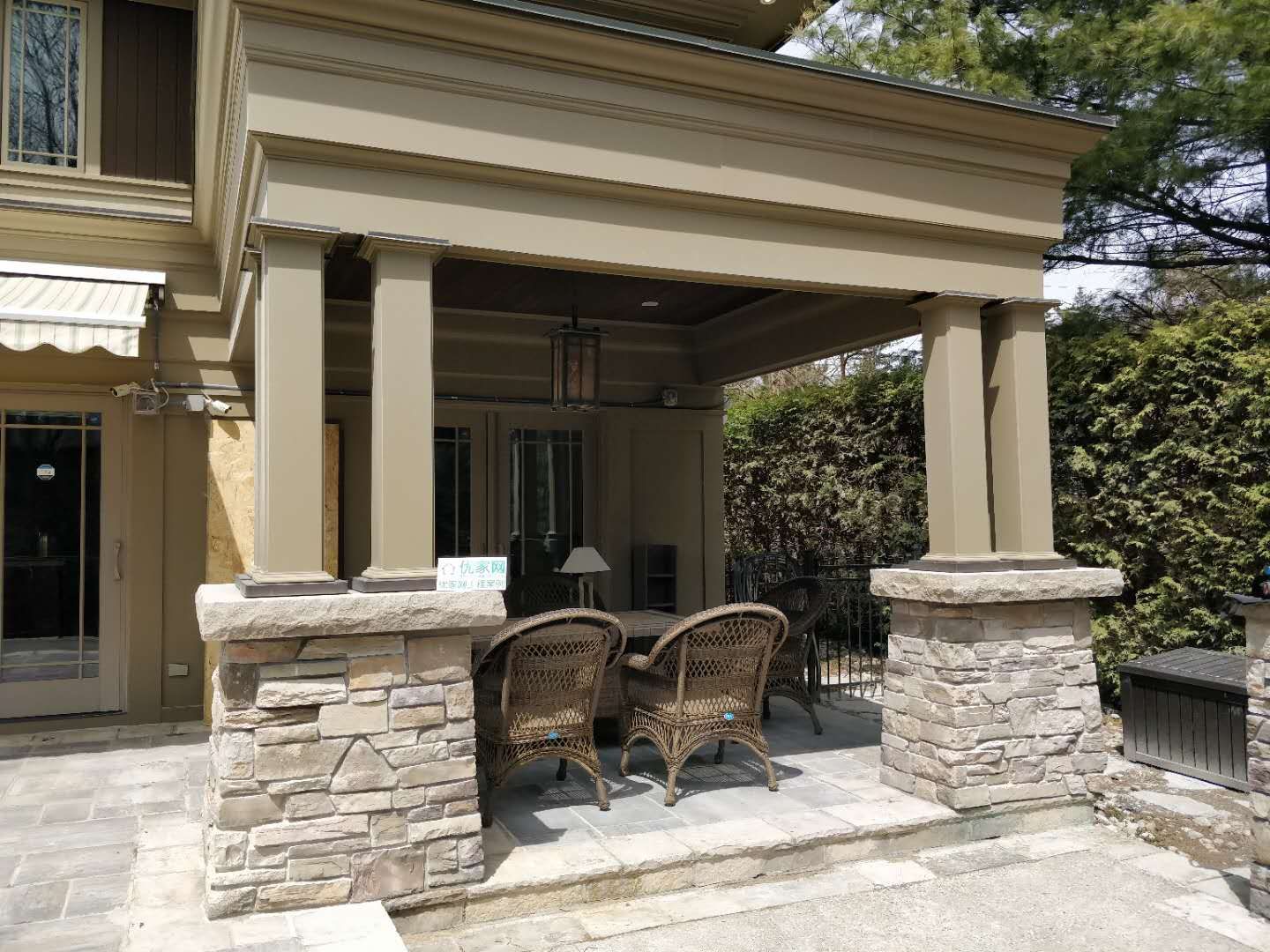 Oakville backyard covered patio featuring stone columns, architectural pillars, and a spacious seating area. Designed for comfort, shade, and elegant outdoor living.