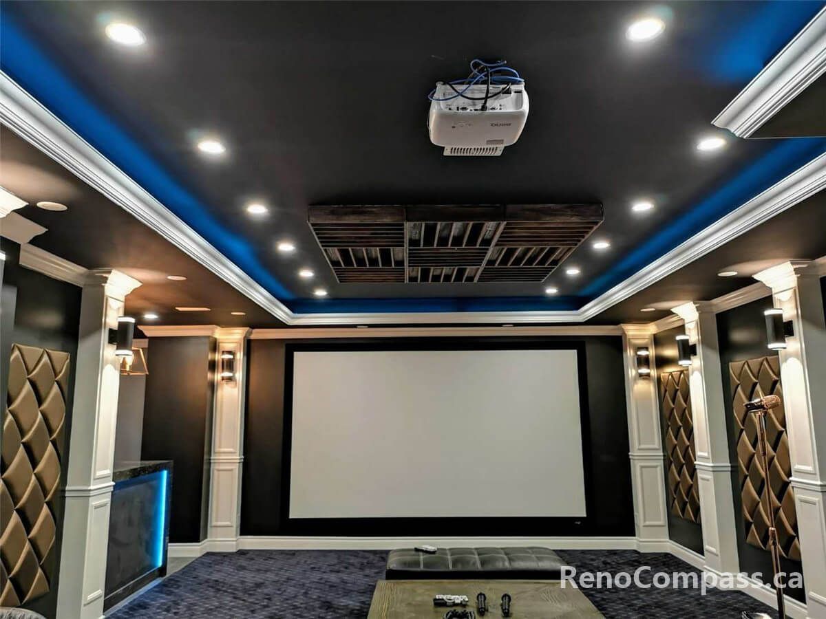 High-end home theatre installation in Mississauga featuring a large projection screen, custom ceiling lighting, built-in speakers, and luxury reclining seating. This professionally designed basement cinema combines acoustic optimization, modern lighting design, and premium finishes to create an immersive private movie theatre experience for homeowners seeking comfort and entertainment.
